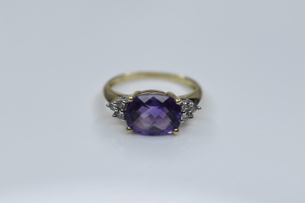 14K Gold Amethyst and Diamond Ring 3.12g: Ring size is approx. 7 and weighs approximately 3.12g. Stunning Yellow Gold Cushion cut Amethyst and diamond ring amethyst approx. 3ct with 6 diamond full accents each approx. .05 full cut