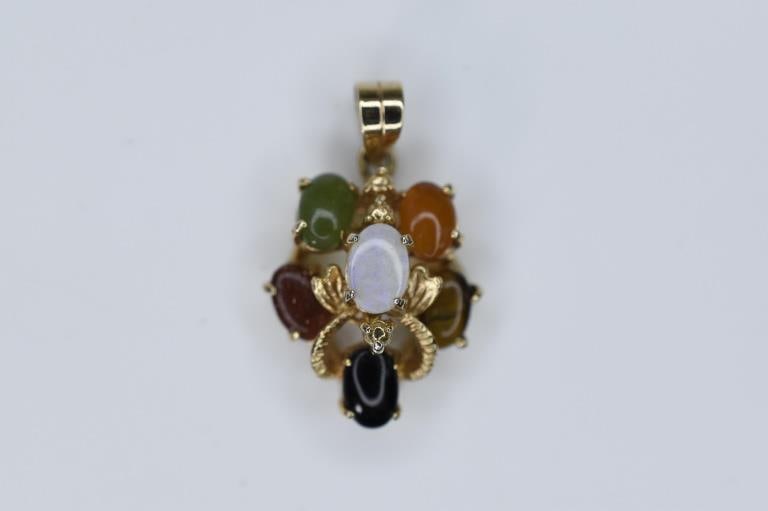 Yellow Gold Pendant 2.21g: Yellow Gold Pendant mounted with (6) capuchins including quartz, tiger?s eye, jade, and others. Measures approx. 1" and 2.21g in weight.