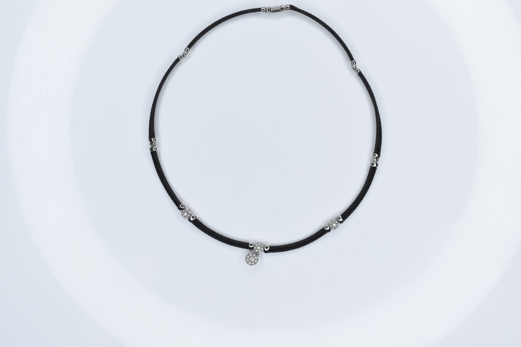 14K 750 Gold Necklace Charriol.: A braided fiber necklace with 750 silver accoutrements.