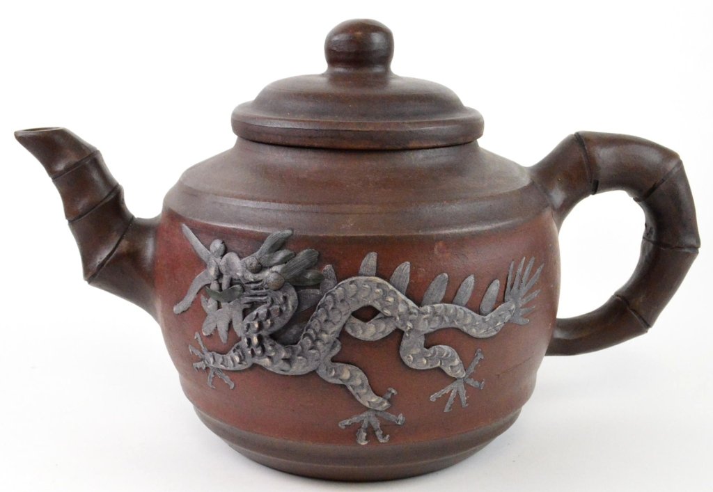 Chinese Yixing Xisha Teapot: Large Chinese Yixing Xisha teapot with dragon relief and bamboo design handle and spout. Has kiln makers mark on bottom of lid. About 7 diameter x 8" high x 13" long"