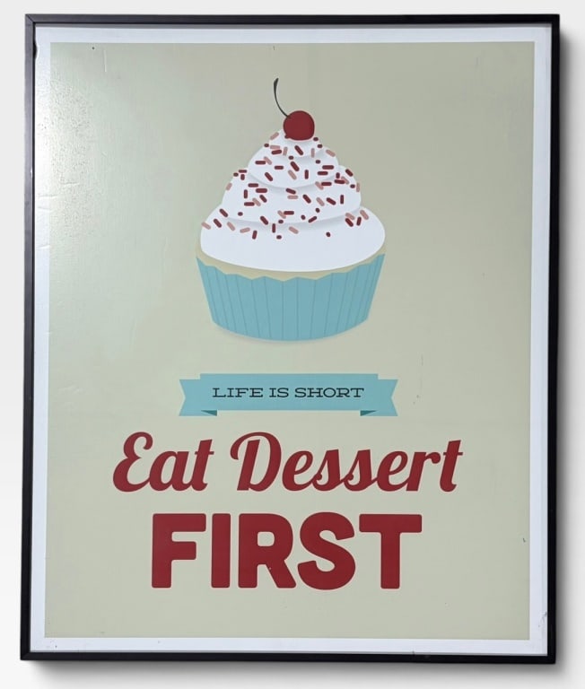 Genesis Duncan "Eat Desert First" Lithograph: Circa 1965-1970, Framed wall art featuring a cupcake illustration with a cherry and sprinkles, accompanied by the text 'Life is Short, Eat Dessert First.' The design is set on a light background with 