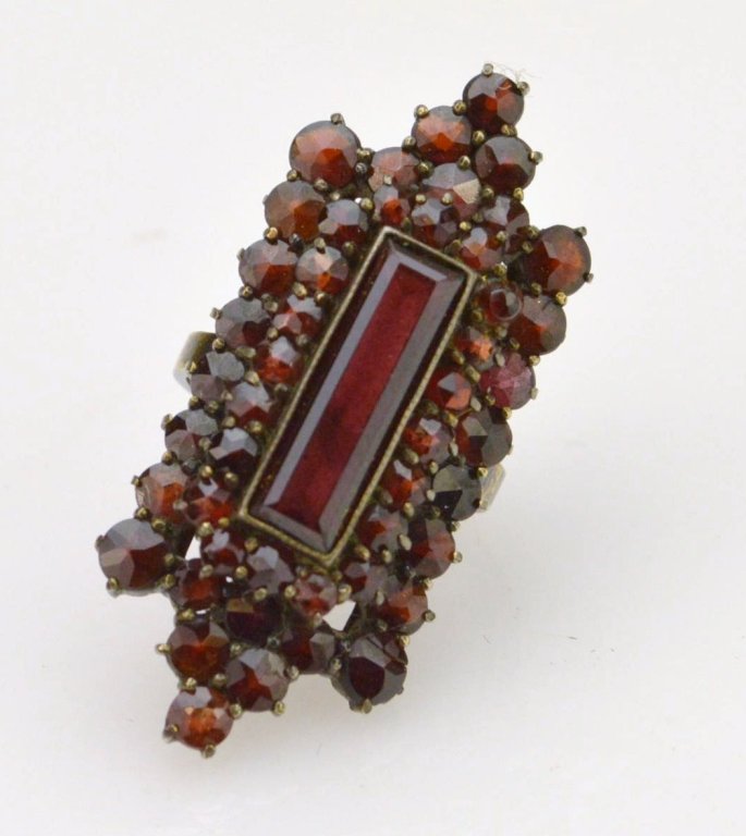 14K Garnet Cluster Ring: 14K yg marked setting with a large cluster of garnets including a center rectangular cut of approx. 16mm x 5mm, ring size 5 1/4, 4.4dwt.