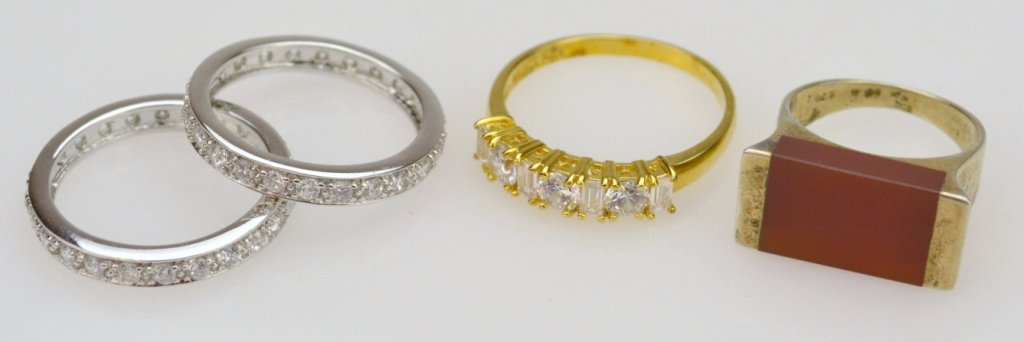 Four Sterling Rings.: Including three with rhinestones and one with a carnelian tablet, 0.47ozt total.