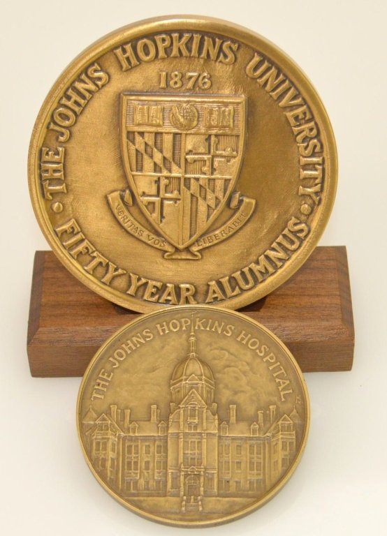 Johns Hopkins Bronze Medal Lot: Lot includes a Johns Hopkins Bronze medal commemorating 50 years of service, dating 1889 to 1939 by the medallic art company. also a Johns Hopkins 50 year alumnus medal awarded to Dr. George Thomas in