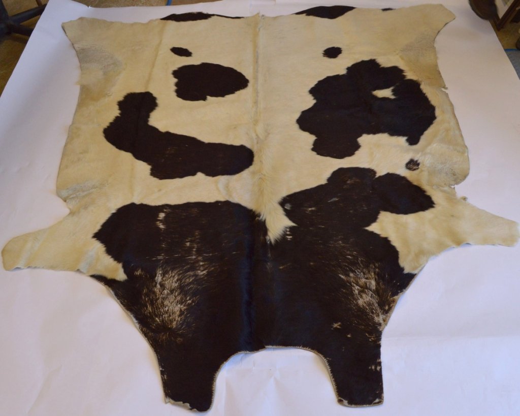 Large Cow "Fur On" Hide Rug and/or Wall Hanging: Large Cow "Fur On" Hide Rug and/or Wall Hanging. Both sides are soft and clean. Doesn't look like it was ever walked on. Professionally Tanned Hide. 86" x 83"