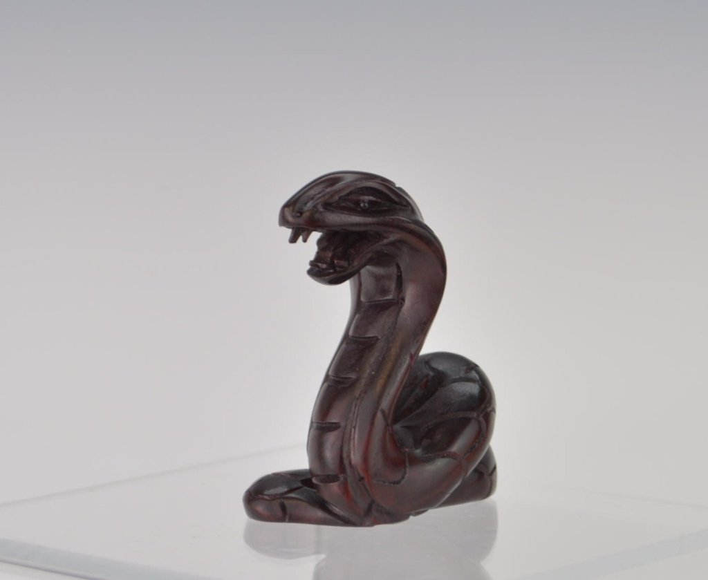 Chinese Carved Wood Cobra Netsuke: Chinese Carved Netsuke in the form of a Cobra arched and ready to strike position and showing Fangs. 2 1/8" High