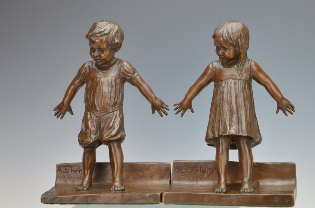 Abastenia St. Leger Eberle Bronze Bookends: Pair of bookends of a boy and girl playing hide and seek. Very good condition. Signed A. Eberle copy. 1911 Each measures 6 3/4" high.