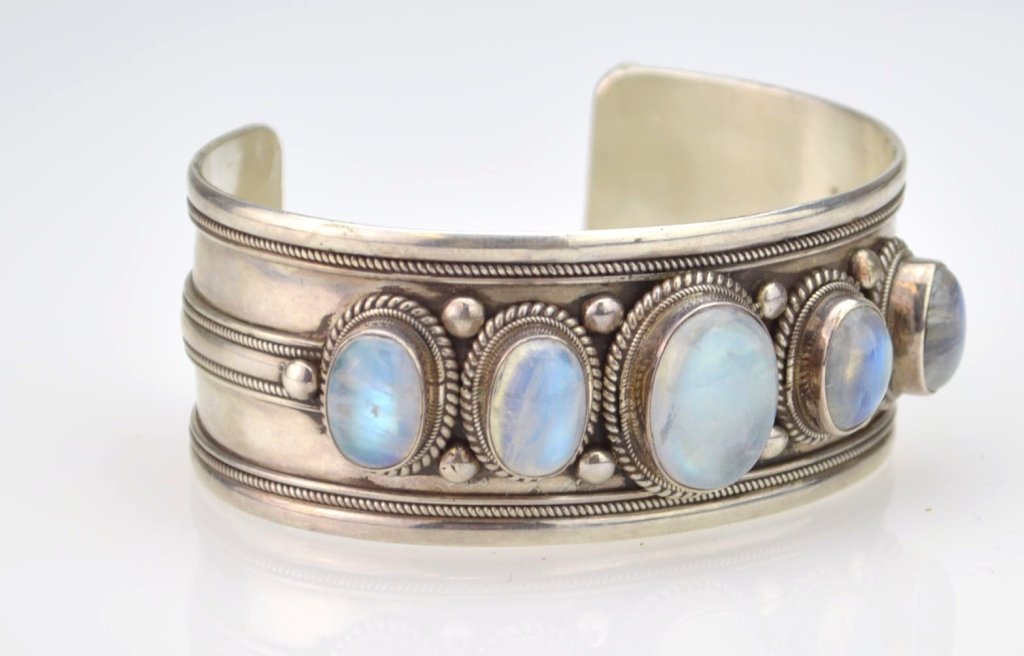 Labradorite & Sterling Cuff Bracelet: Cuff bracelet marked 925 with applied sterling banding and contains five bezel set oval labradorite cabochons, stones range from 12mm x 9mm to 17mm x 12mm, 30mm overall cuff width. 2.088 ozt