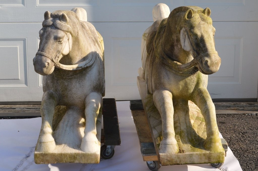 Monumental Chinese Carved Marble War Horses: The magnificent carved marble horses, imported from China, would grace any doorway they guarded. They measure 55" x 30" x 13". One horse has a repaired tail.