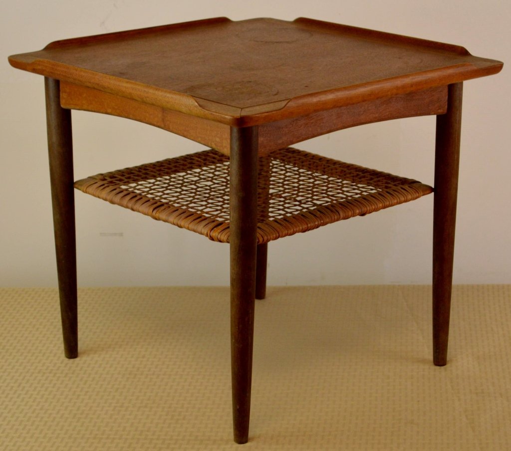 Poul Jensen Mid Century Modern Table for Selig, Denmark: Poul Jensen occasional table, for Selig, Denmark, teak, square top with raised lip to edges over a caned lower shelf, original finish, Selig metal decal affixed to underneath of table. Measures 18.5"
