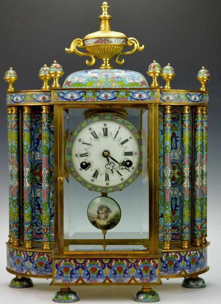 Cloisonne Clock, Wide Base: Cloisonne clock, wide and heavy design. Painted enamel face and pendulum. Original key. Beveled glass. Clock did not work during observation. Unmarked. Measures 18 inches tall and 13-1/2 wide.