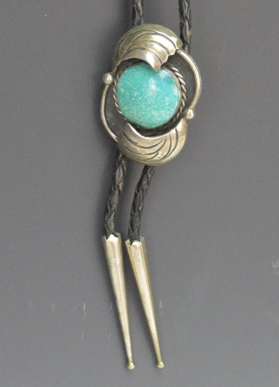 Jose Luis Flores Sterling Silver Bolo Tie: Jose Luis Flores Sterling Silver Bolo Tie, signed JLF and marked sterling. Centerpiece measures 1.75"