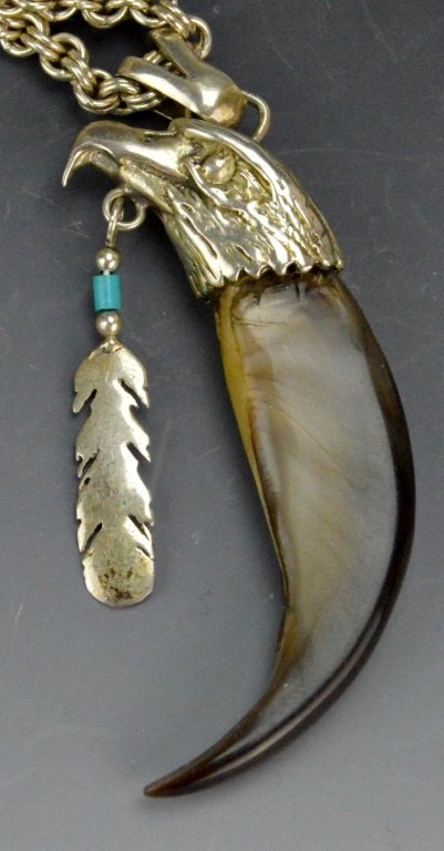 Navajo Silver Eagle and Bear Claw Pendant: Navajo pendant with bear claw mounted to the head of an eagle. Has large 1 ozt sterling silver necklace.