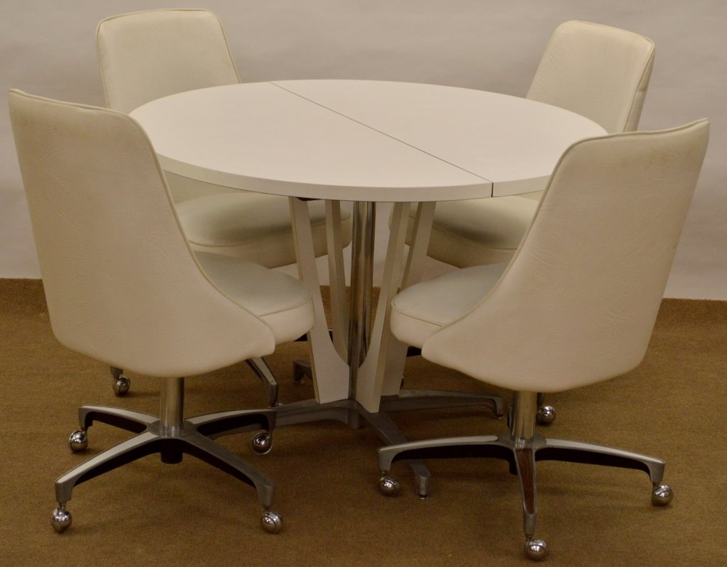 Chromecraft Kitchen Table and Chairs: Includes (4) chairs and table measuring 42" x 29". Chairs are 35" x 19" x 17" and have some rubs or stains, and the laminate on the bases are missing on a few stems.