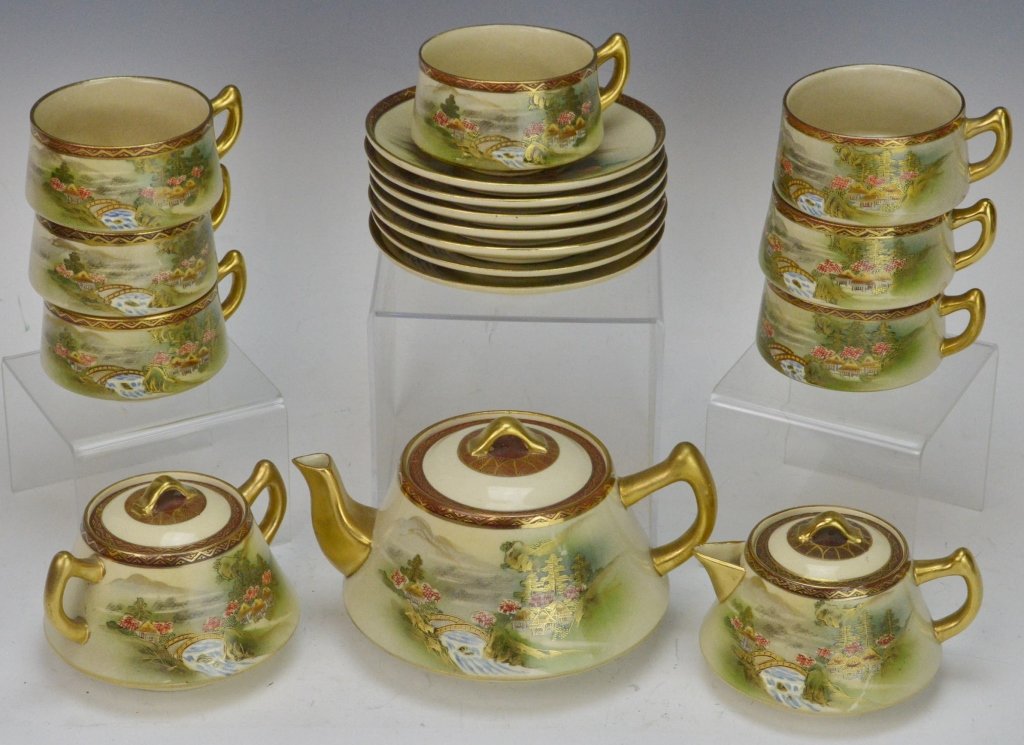 Kutani Japanese Porcelain Tea Set: Kutani fine porcelain tea set. Includes teapot, creamer, sugar, (7) teacups and saucers. One saucer has small chip.