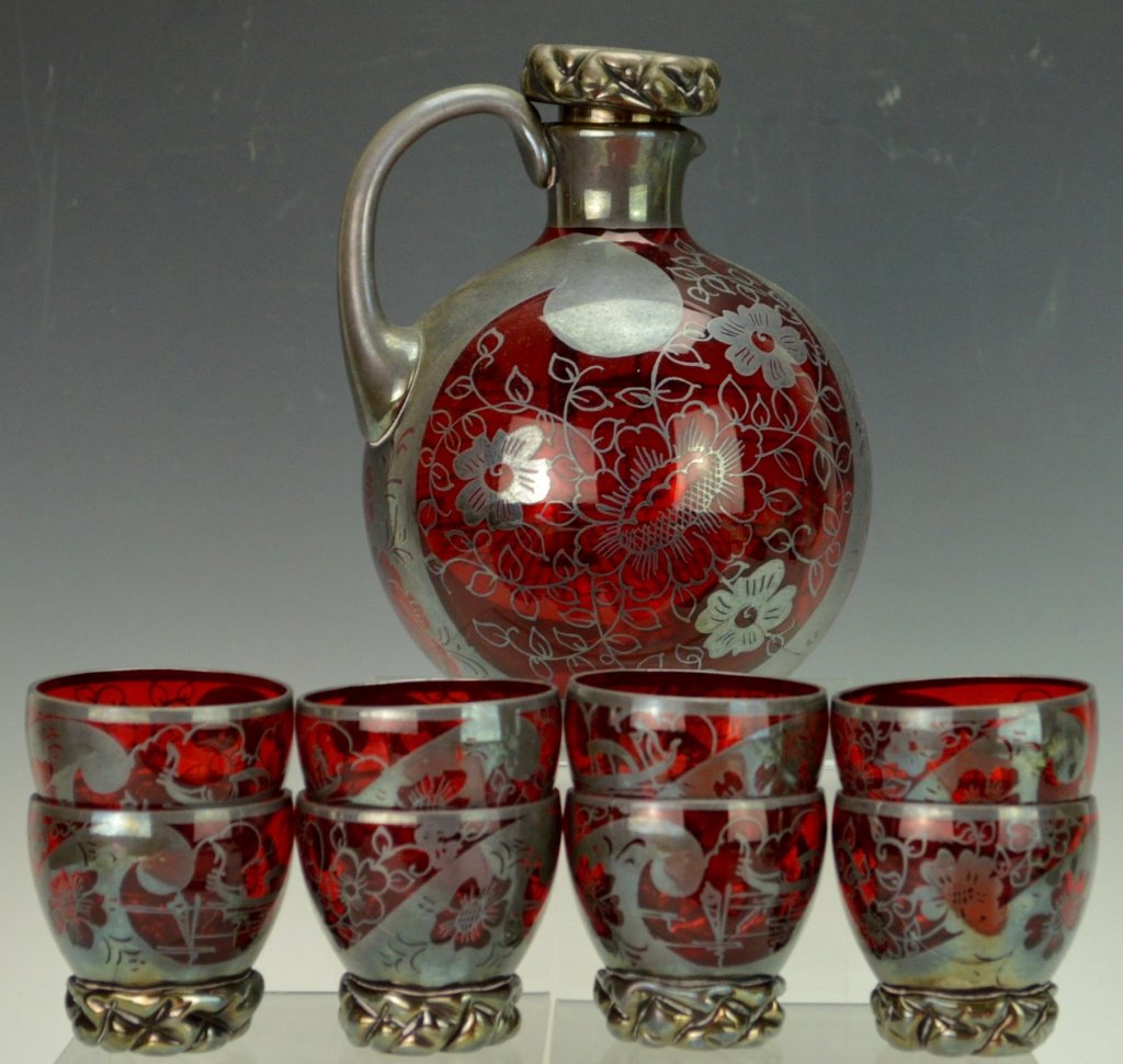 Silver Overlay Ruby Glass Pitcher and Cups: Includes eight (8) cups and decanter. Matching floral glasses. Silver-plated handle and stopper. No damage seen. Measures 6.5" tall.