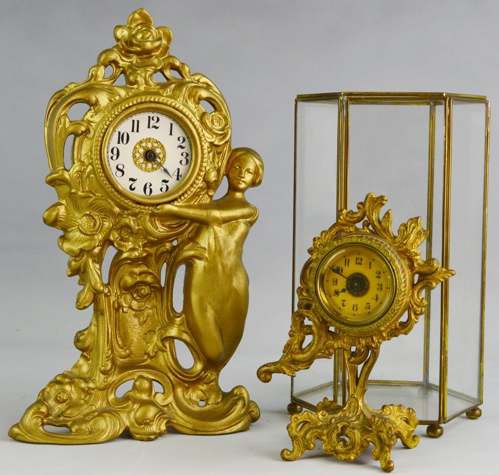 Brass Clock Grouping: One clock is an anchor brand the other is a warner. The anchor measures at 10" x 6". The Warner measures at 13" x 7 1/2".