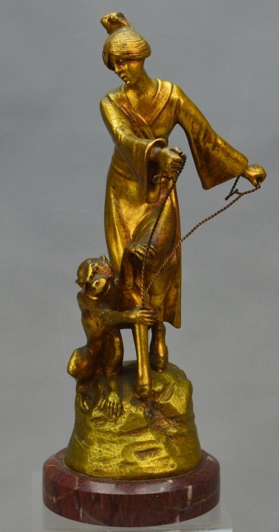 G. Flamand Bronze Sculpture: Georges Flamand gilt bronze sculpture of a woman and monkey. Signed. G. Flamand and secured to a red marble base. Measures 10" including base.