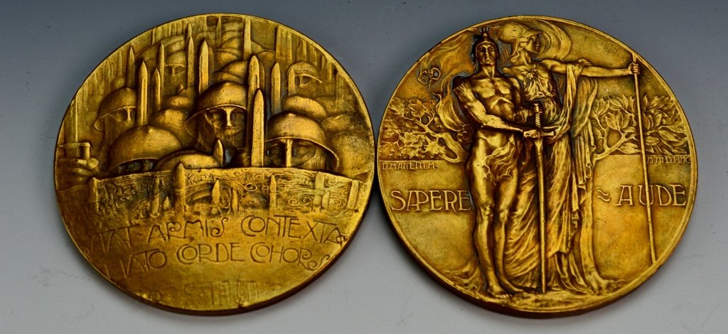 M. Nelli Bronze Medal Grouping: Includes (2) M. Nelli inc Medals. First Depicts soldiers in Formation, reads Stat Armis Contexta Elato Corde Cohors. Reverse depicts Machine gun crew reads, "Cor Omnibvs Vmvm." Means, "All one 's hear