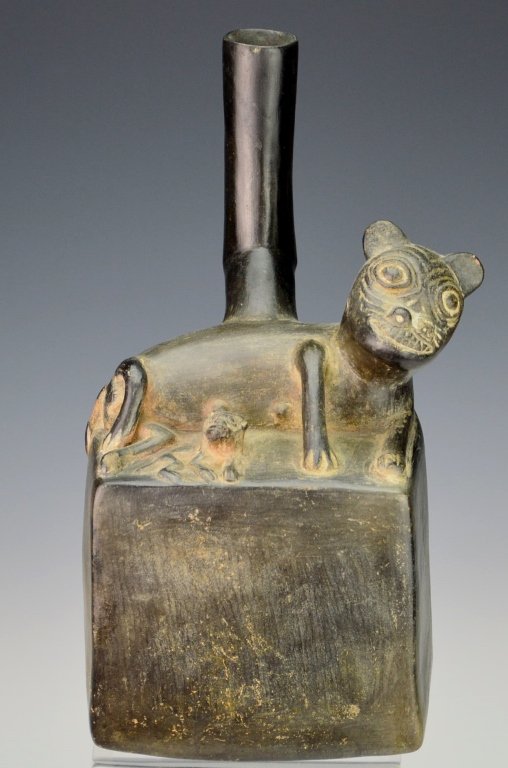 Chimu Pottery Vessel : Sotheby's: Circa A.D. 1100-1400. Rectangular shaped stirrup-spout vessel, the top molded with a reclining female feline figure, one of her young lying nearby, with large lozenge shaped eyes, incised snout and di