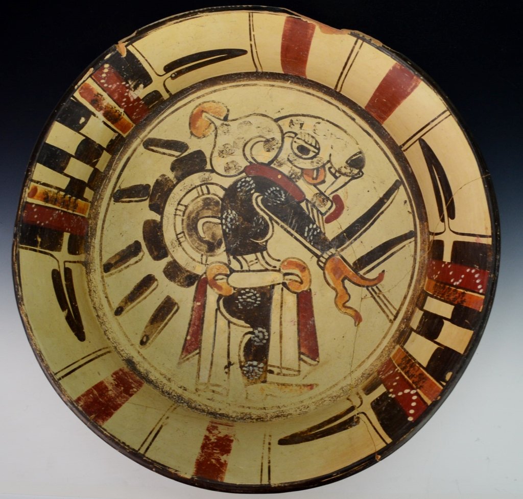 Veracruz Polychrome Plate, Los Tuxtlas : Sotheby's: Late classic, c. 550-950, supported on tripod rattle legs, decorated in the tondo with a rabbit headed priest figure, standing with long right arm outstretched, large head with open mouth and tapered 