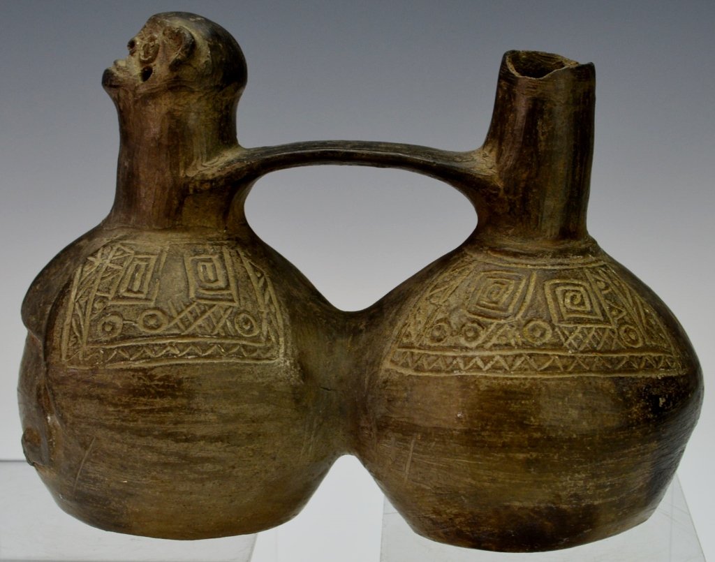 Chimu Whistle Vessel : Phillips: c. 900-1400 A.D. double chambered, one side molded with an animal head, the rounded shoulders incised with geometric decoration. Height 6.75". Provenance: Phillips 3/29/80 auction, lot # 36. From the 