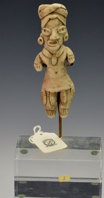 Modeled Clay Figurine : Christie's: Guerrero, Mexico 300-100 B.C., modeled grayware figurine of a woman, standing with her stub arms at her sides; she wears a tubular sheath dress decorated by suspended feathers at the bottom and has a 