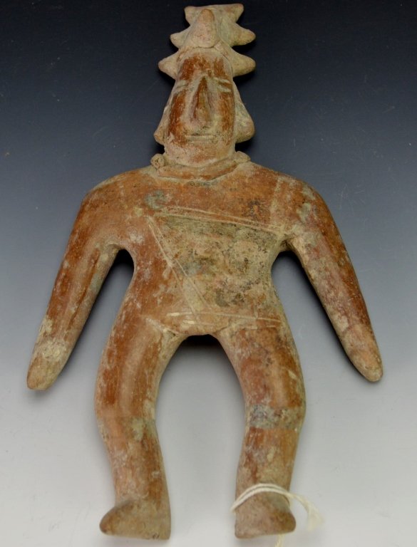 Colima Standing "Gingerbread" Man : Christie's: Colima, Mexico, 250-650 A.D., Flat hand-modeled clay figurine of a man wearing an incised costume. On his head is a conical headdress ornamented by three pairs of horns. Height 7". Provenance: Christi