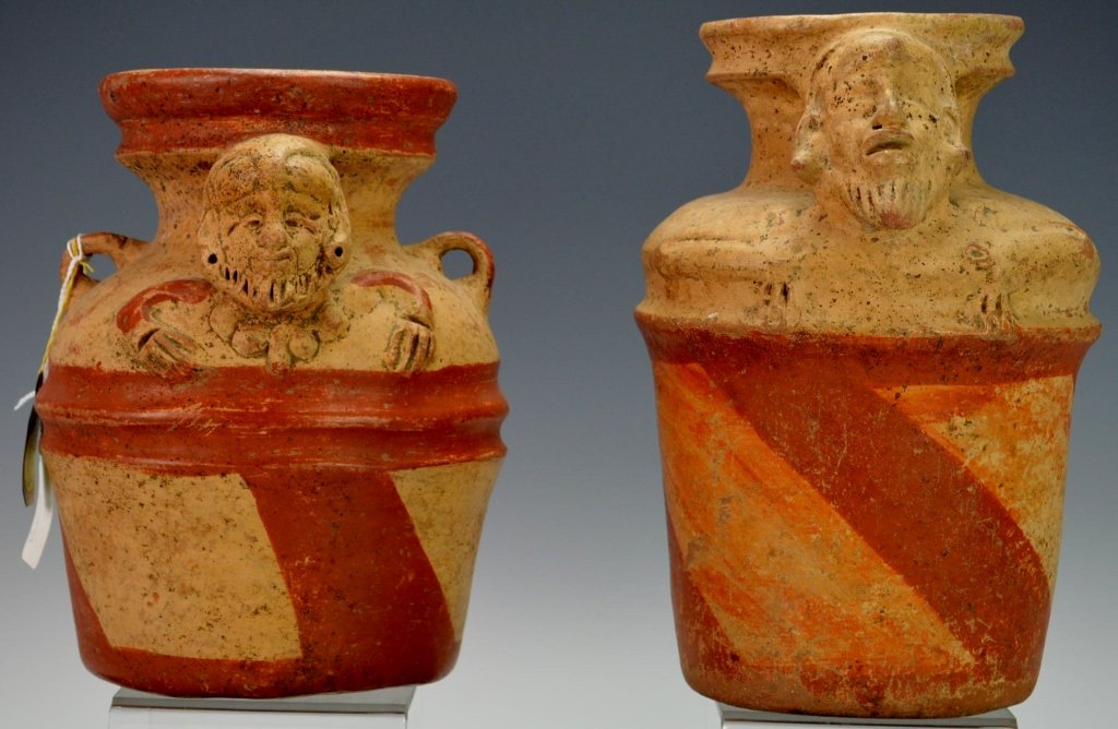 Pair of Mayan Effigy Jars : Sotheby's: Quiche, post Classic, 900-1200 A.D., each of sturdy ware with cylindrical body tapering into flaring spout, with the of the aged God N. projecting on one side, with goateed chin, slit eyes, the bent a