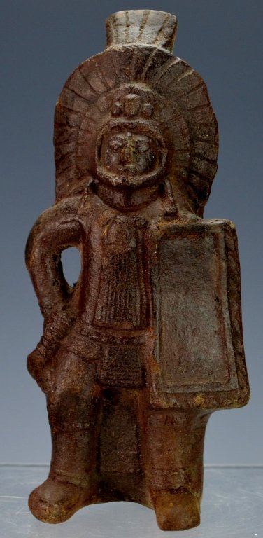 Mayan Molded Warrior Effigy: Classic, Chajul, NW Guatemala, molded terracotta warrior effigy with shield and club wearing elaborate headdress and battle gear. Strikingly similar to Jaina molded figures. Intact, except for tip of 