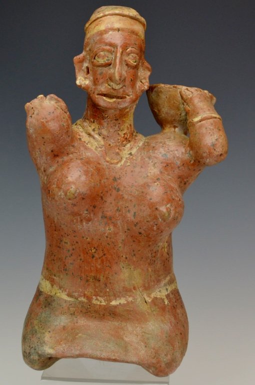 Jalisco Kneeling Female Figure : Sotheby's: Protoclassic period, c. 100 B.C. - 250 A.D., the thick body with large protruding breasts, truncated arms, one supporting a bowl on the left shoulder, the head with clearly defined features. Height 14
