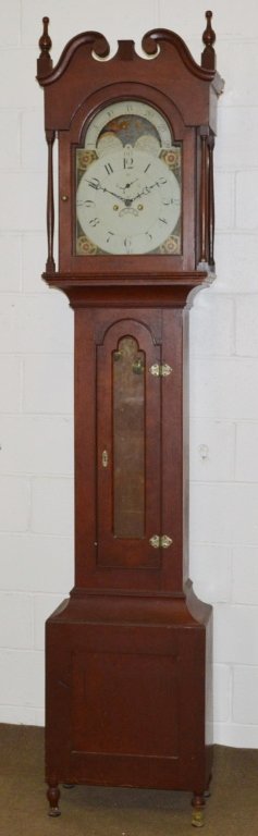 John Samuel Krause Sheraton Tall Case Clock: A Bethlehem Pennsylvania tall case clock made by John S. Krause Circa 1800-1820. Clock is in its original red finish. It has carved broken arch top resting on a bonnet with (4) full columns. There are