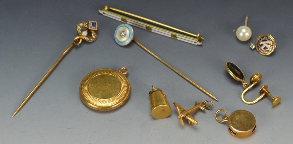 14K YG Jewelry Grouping: Including a blue sapphire and seed pearl stick pin; enameled stick pin; locket; enameled bar pin; Kiwanis pin; pearl tie tack; single earring; and three charms, 11.4 DWT.