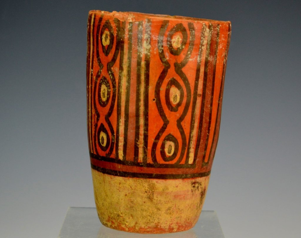 Mayan Polychrome Vase: Late Classic, c. A.D. 550-950, in black, white and deep brownish - orange on a pale orange ground, with narrow vertical panels. Height: 5.25". From the living estate of Professor Williamson, Lehigh Un