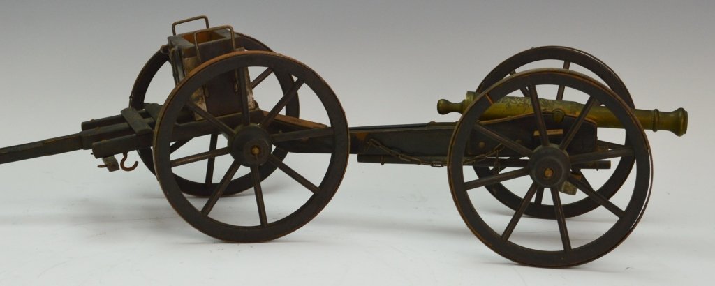 19th C. Brass Cannon with Carriage: Brass cannon with hammered flora decoration, wooden wheels with applied metal covers, includes original ramrod and bucket. Cannon measures 7", Carriage measures 29"
