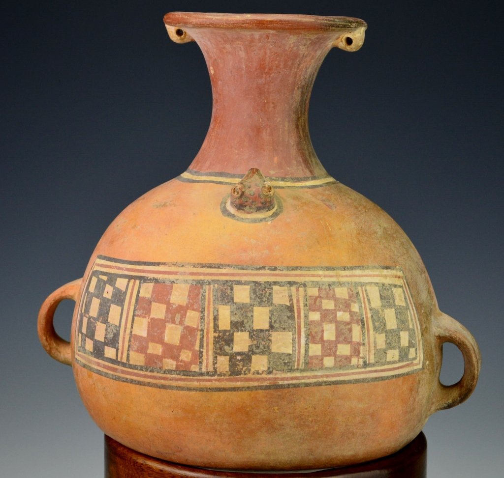 Peruvian Pottery Vessel : Sotheby's: Inca Period, c. 1450-1532. Aryballus of typical form with pointed base, twin lug handles on the globular body, cylindrical neck, outward flaring rim decorated twin pierced lugs, body molded with a tri