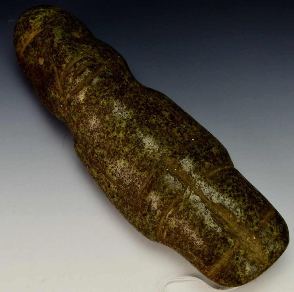 Guerrero Stone Standing Figure : Sotheby's: Mezcala, late preclassic, c. 300-100 B.C. with incised arms held at the waist, the tapering head with sunken mouth, wrinkles along the sides, and drilled eyes; in dark green speckled stone. Height 7".