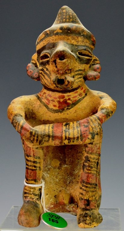 Nayarit Diseased Male Figure : Sotheby's: Protoclassic, c. 100 B.C. - A.D. 250, seated with elbows resting on raised knees with protruding deformed lips and swollen nose, wearing a peaked cap and earrings, and painted overall in buff with bla
