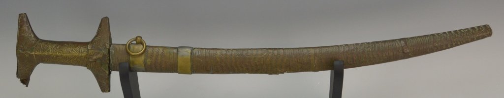Jiboula Sword: Morocco, circa 19th century.The blade has a triple blood groove as well as dozens of "x" small dot markings. The blade and sheath are in good condition, but small edge has rough patch. The hilt comple