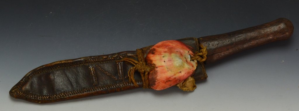 Baule Knife: Ivory coast, Baule. Wood handled knife, hide sheath with dyed shell. Sheath has decorative stitching and one loop for wearing. Measures: 10.5" overall, 8.5 sheath, 6.5" blade,