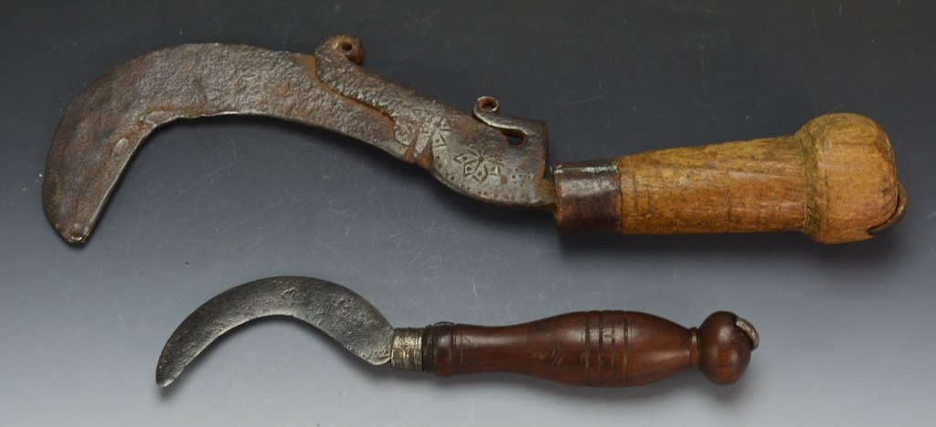 Arit Knife Grouping: Malaysia, 19th century, sickle type knife that takes other names and forms in the region, Sabit, Sadeueb, or Kapor Sabit. Includes (2), first measures 11.5" overall with 7" blade (loose in handle), se