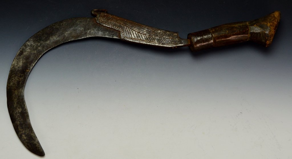 Arit Knife: Malaysia, sickle type knife that takes other names and forms in the region, Sabit, Sadeueb, or Kapor Sabit. Measures 15" overall, with 10" blade that has feather style decoration. Pictured in Islamic 