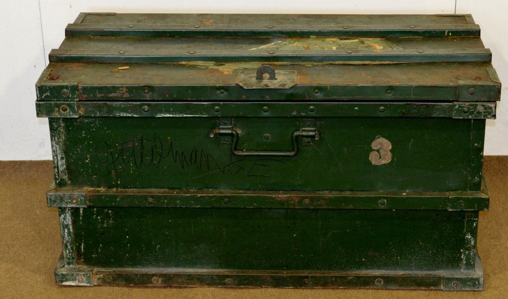 Industrial Lock Box: An industrial lock box in green paint. Retains all four of it's handles one located on each side. Would make a great coffee table. Measures L44" x D21.5" x H24" retains early newspaper lining dated 19