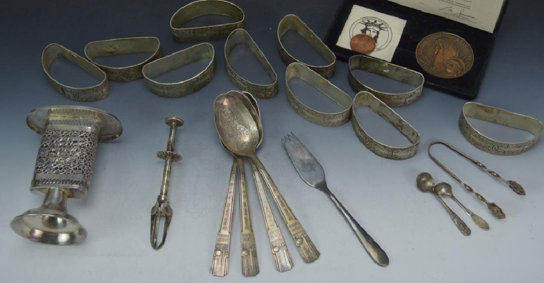 Silver Grouping: Includes sterling spoon, sterling candle holder, napkin rings (unmarked) silver necklace (unmarked) , spoons, etc