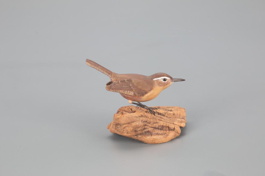 Carolina Wren, Jack and Bette Holt: Jack and Bette Holt Wilmington, DE, c. 1975 4 in. tall A slightly turned-head Carolina wren with incised wing and tail carving. The bird is mounted on a wooden base with "Jack & Bette Holt / Carolina