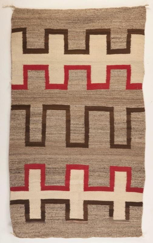 Navajo Geometric Rug: Navajo Geometric Rug c. 1910 In excellent condition. 57 by 33 inches Woven in a simplified early 20th century design, in natural brown, ivory and red wool. In excellent condition. Nancy D. Mitton Coll