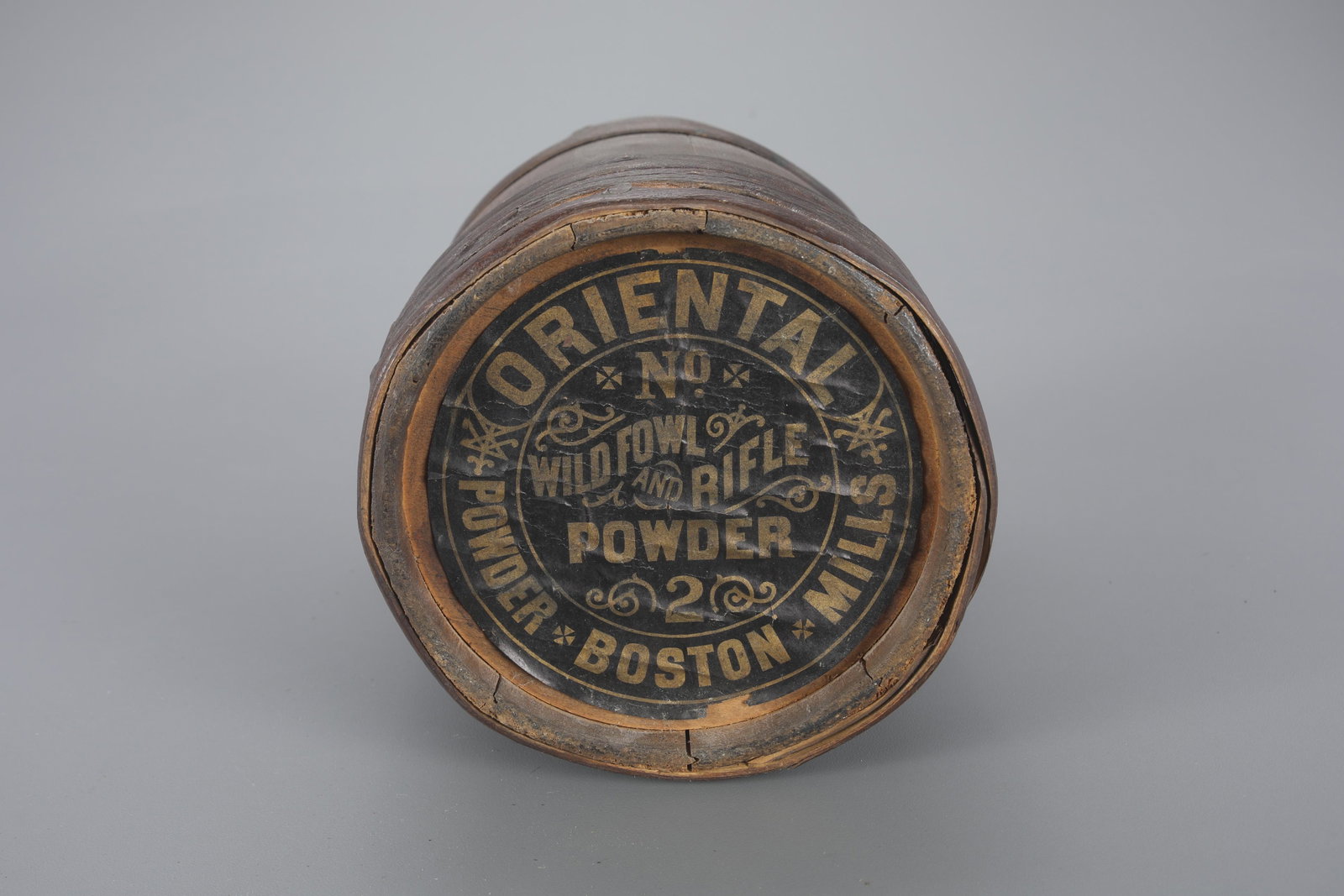 One Oriental Powder Company Keg: One Oriental Powder Company Keg 9 1/2 in. tall Wooden circular keg with "Wildfowl Rifle Powder by Oriental Powder Boston Mills" label. As found. Provenance: Richard Labowskie, M.D. Collection