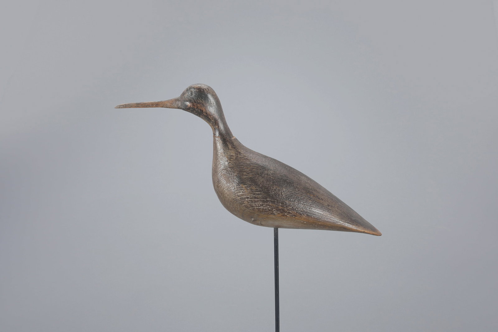 Yellowlegs Decoy: Yellowlegs 12 in. long A contemporary Hudson-style shorebird. Original paint with moderate wear and chip missing from reset neck. Provenance: Wade and Sharon Wander Collection