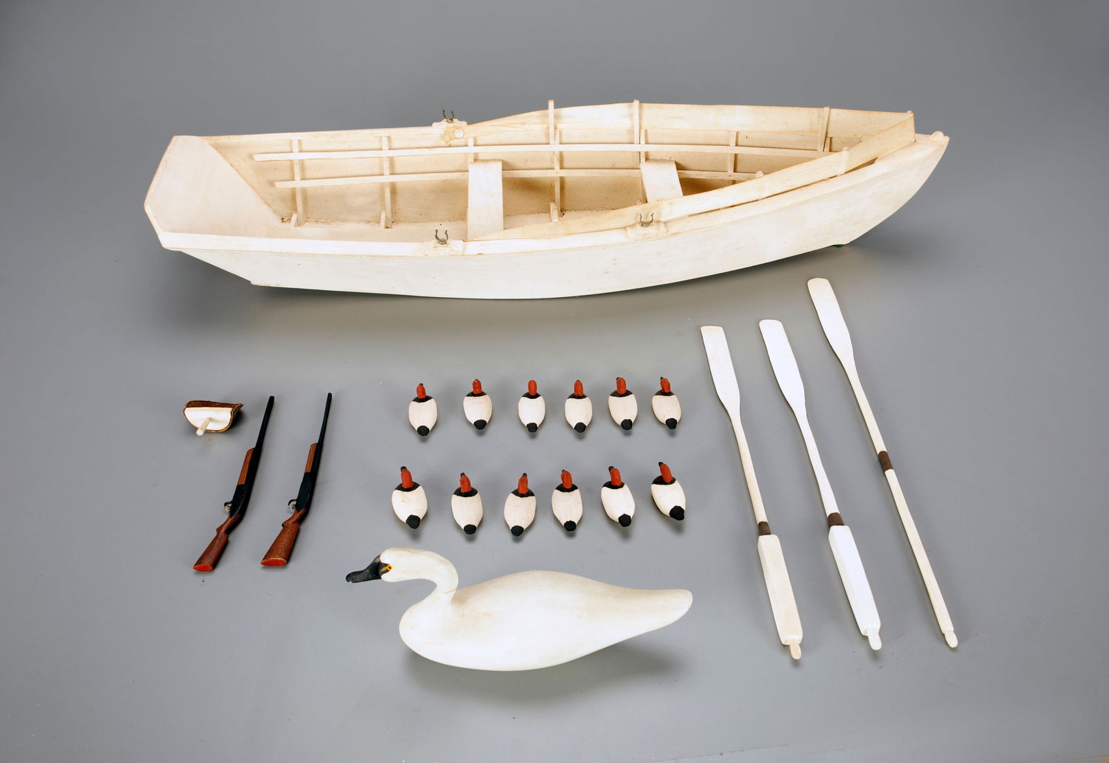 White Boat with Decoys, Oars, and Wooden Guns (1 of 2)