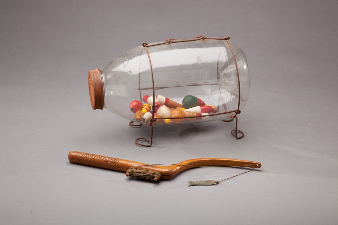 Glass Minnow Trap and Jigging Stick: Glass Minnow Trap and Jigging Stick A first model Orvis Minnow trap made in the early 1970s by Stream and Lake Tackle Company of Grand Rapids, Michigan. Carved from a root, this nineteenth-century fis